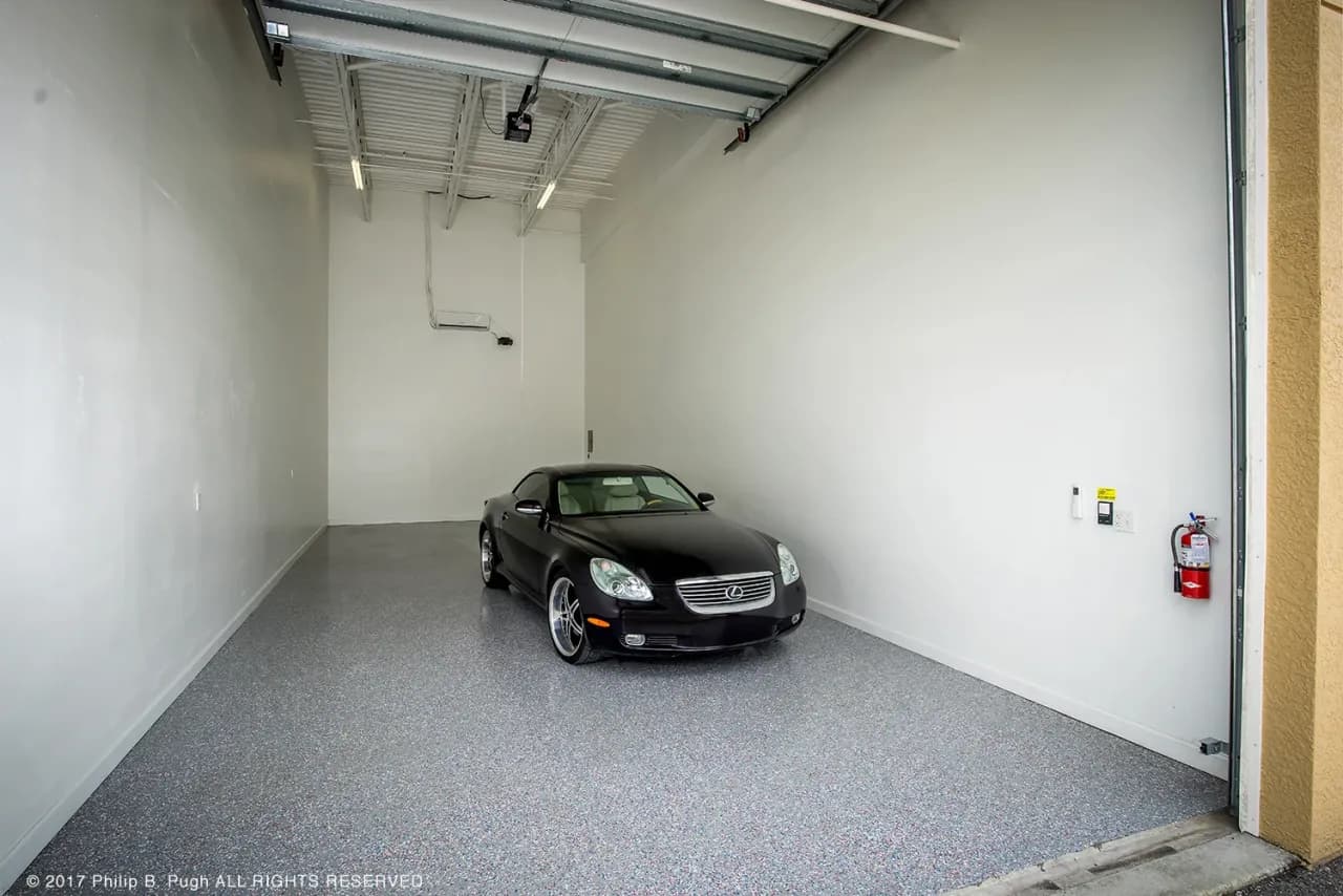 A car parked inside a Vehicle Fortress garage condo unit