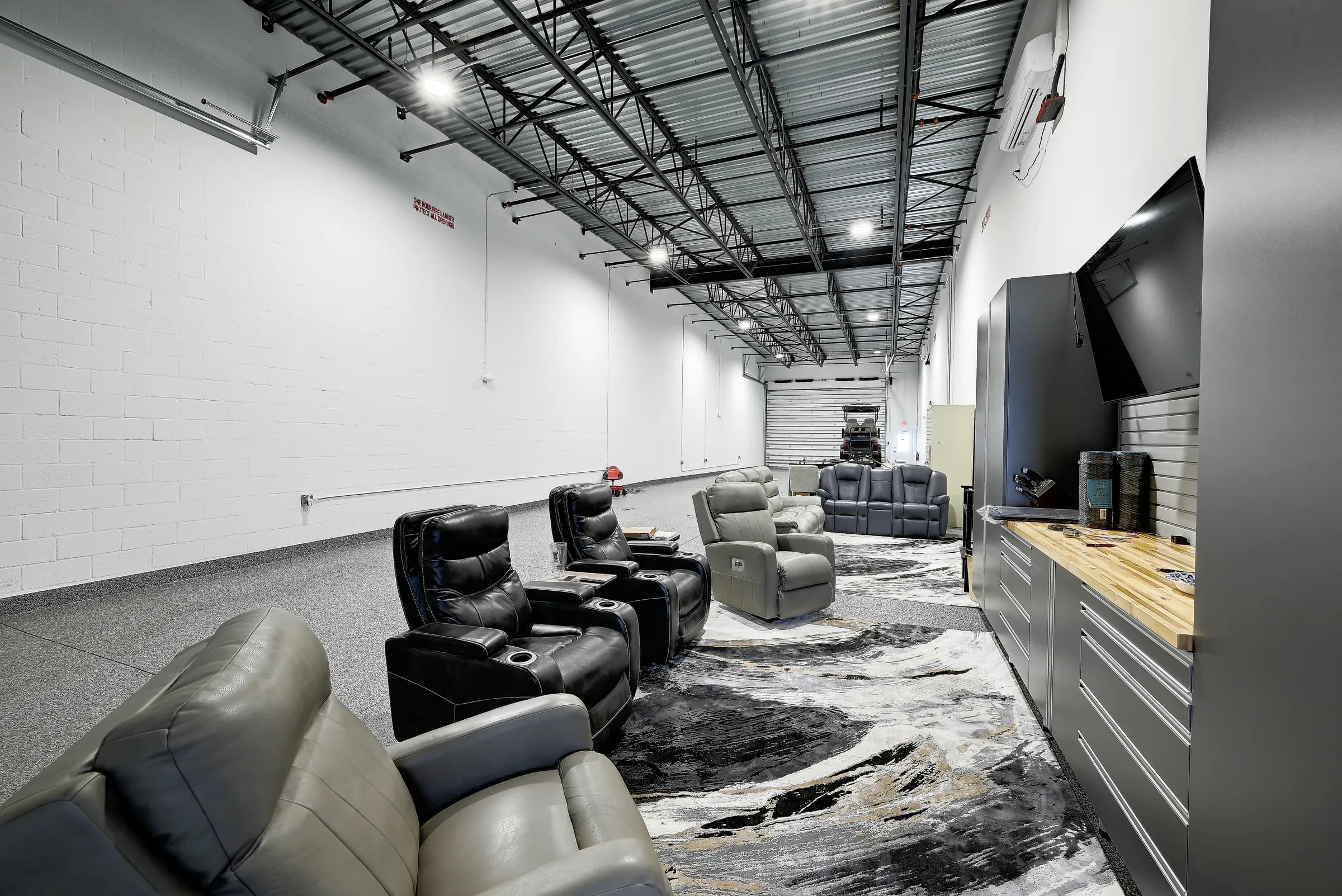 Close view of a unit lounge, with recliners, butcher-block counter and storage cabinets.