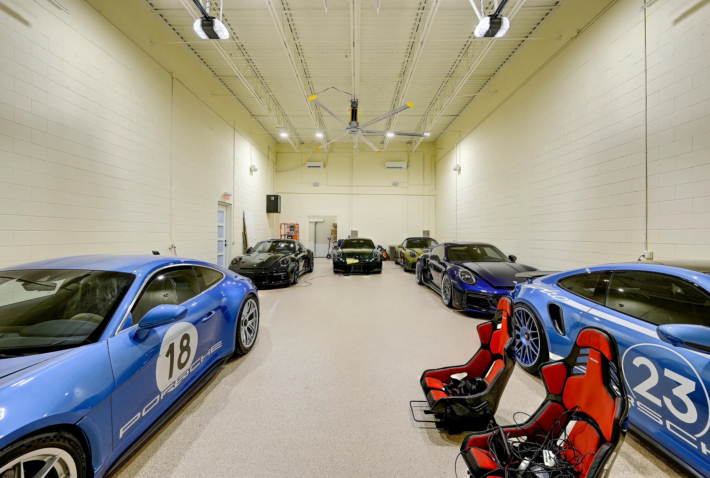 A Vehicle Fortress unit holding a collection of sports cars under a large ceiling fan.