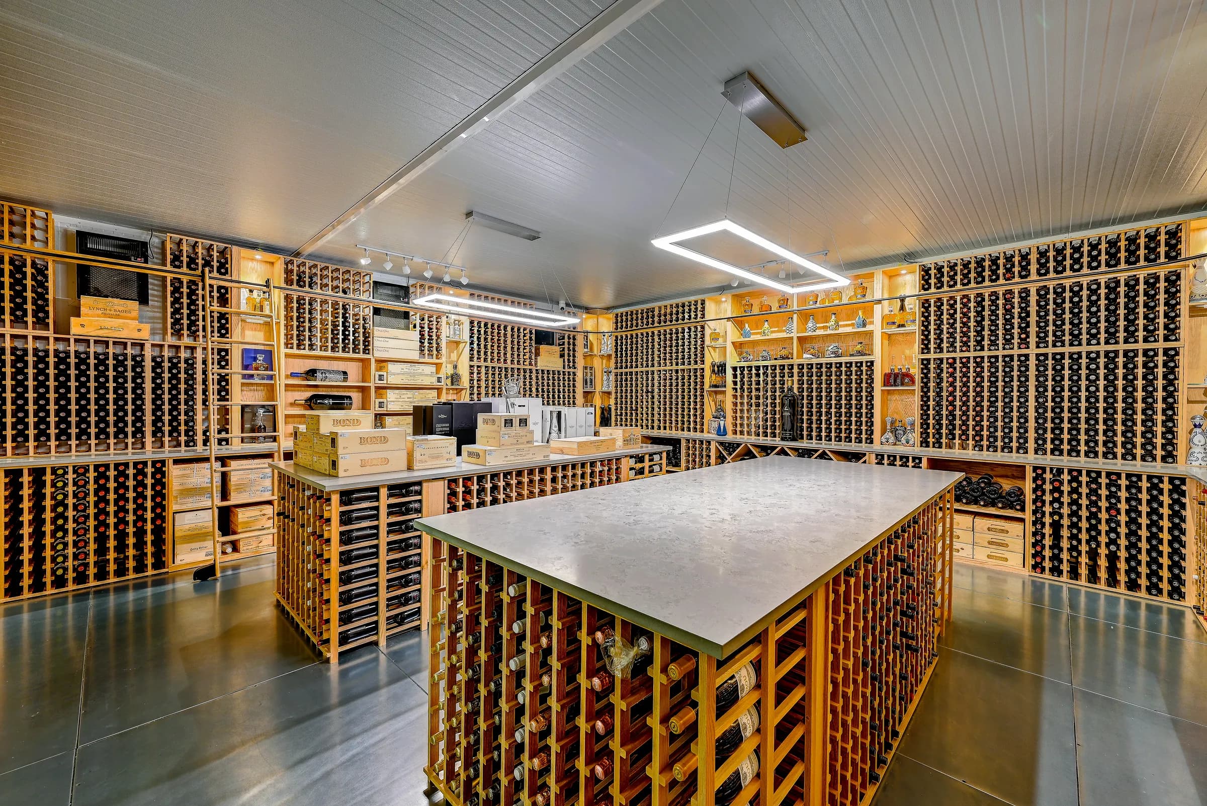 Corner view of the wine cellar with two islands and display shelves.
