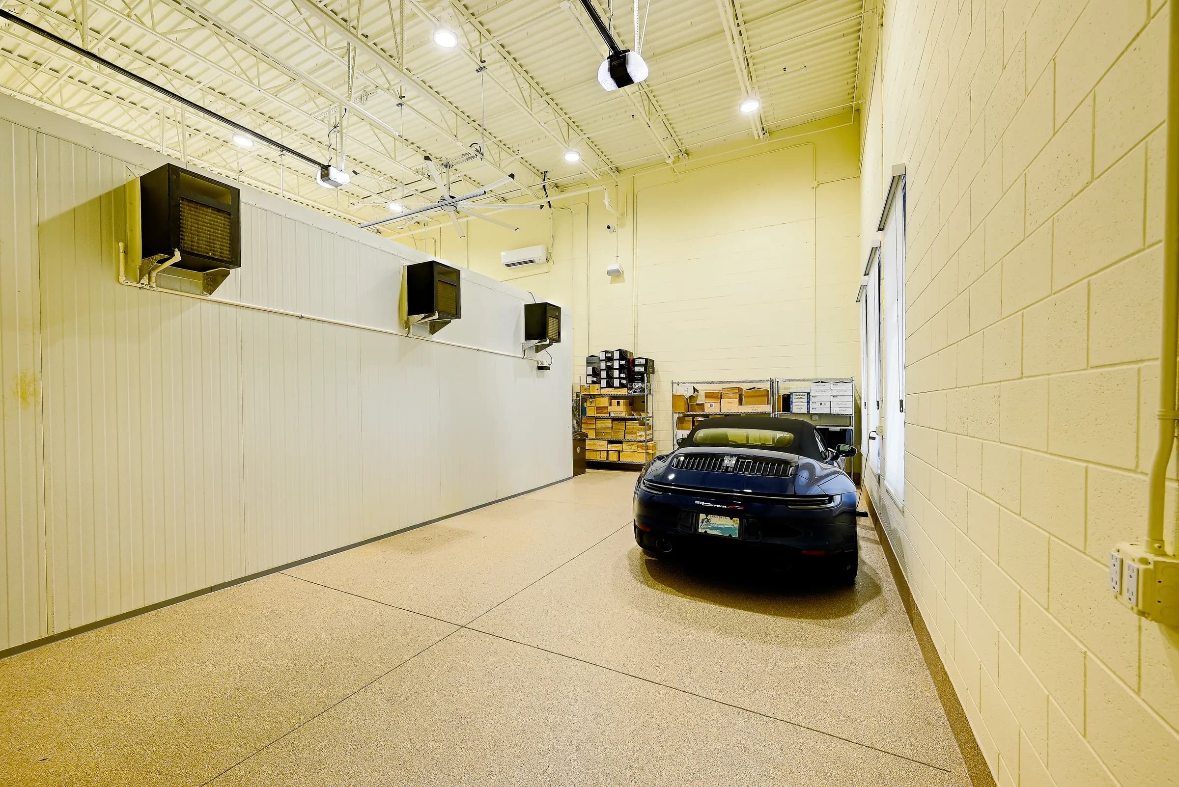 Rear view of the convertible beside the insulated wine room wall and its cooling units.